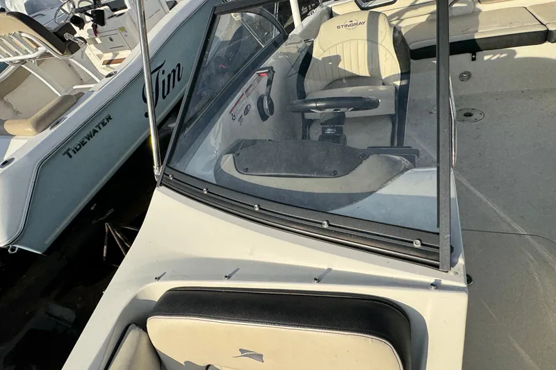 Slide: The Image of 2021 Stingray 201 DC boat interior with steering wheel and seating. - 19