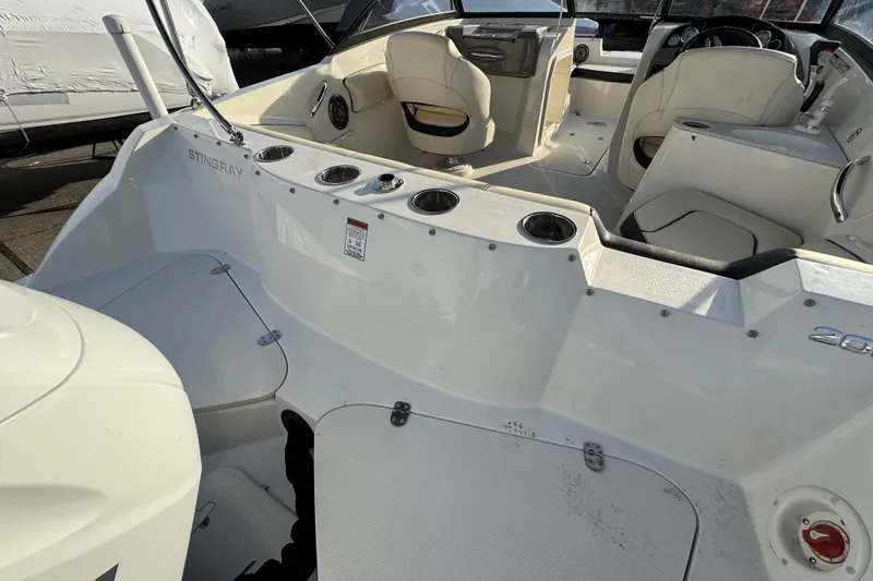 Slide: The Image of 2021 Stingray 201 DC boat interior with seating and cup holders. - 3
