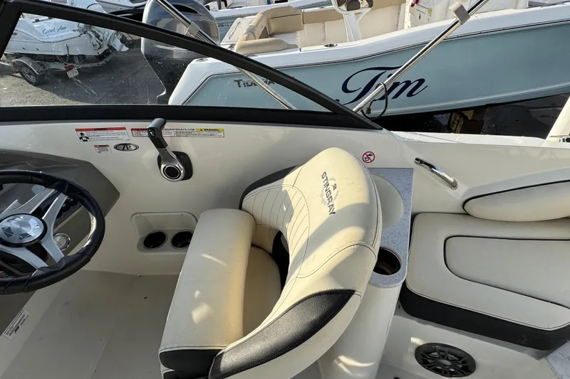 Slide: The Image of 2021 Stingray 201 DC boat interior with steering wheel and seating. - 5