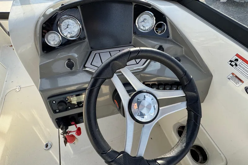 Slide: The Image of 2021 Stingray 201 DC boat dashboard with steering wheel and instrument panel. - 6