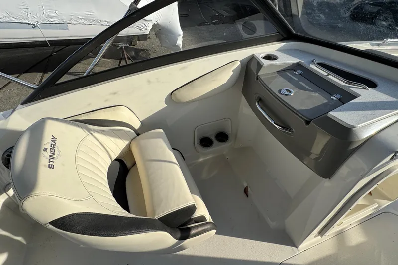 Slide: The Image of 2021 Stingray 201 DC boat interior with steering console and cushioned seat. - 8