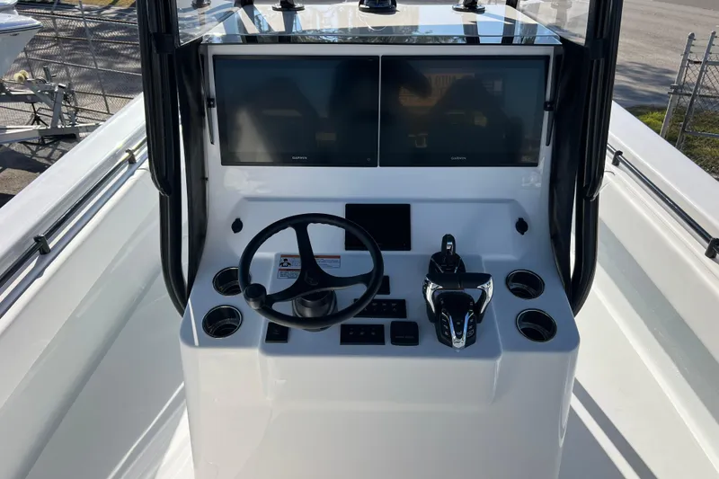 Slide: The Image of 2026 Contender 35 ST boat console with dual screens and steering wheel. - 11