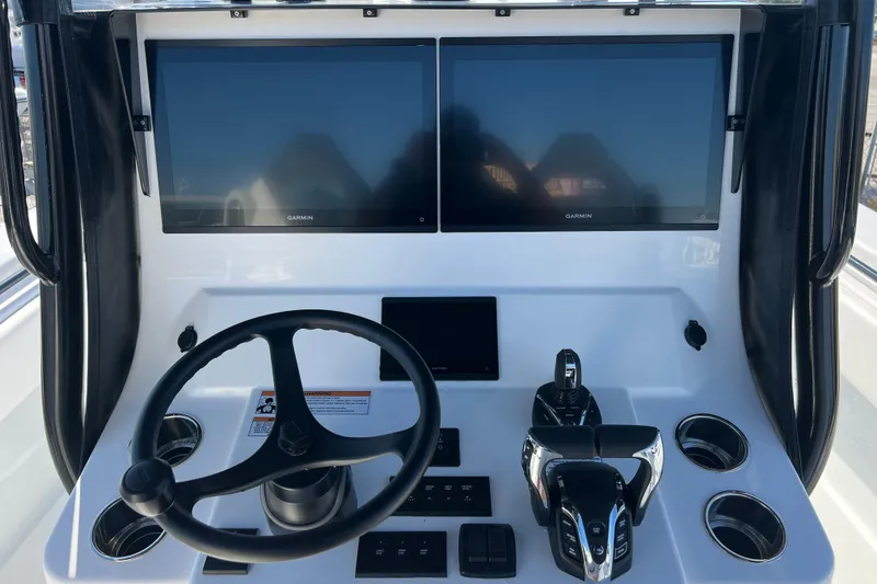 Slide: The Image of Helm of 2026 Contender 35 ST with dual Garmin displays and modern controls. - 12