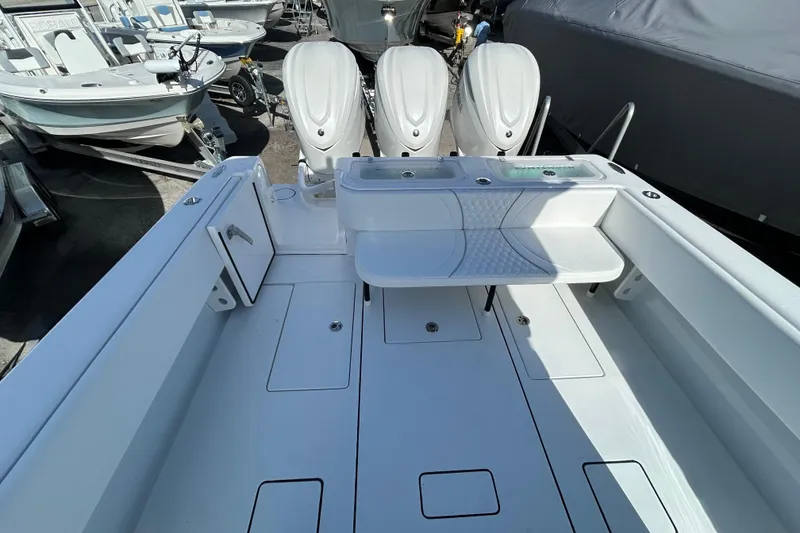 Slide: The Image of 2026 Contender 35 ST boat interior with triple outboard engines, spacious deck, and seating area. - 19