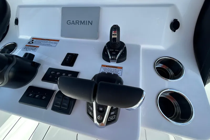 Slide: The Image of Control panel of 2026 Contender 35 ST boat with Garmin display and cup holders. - 22