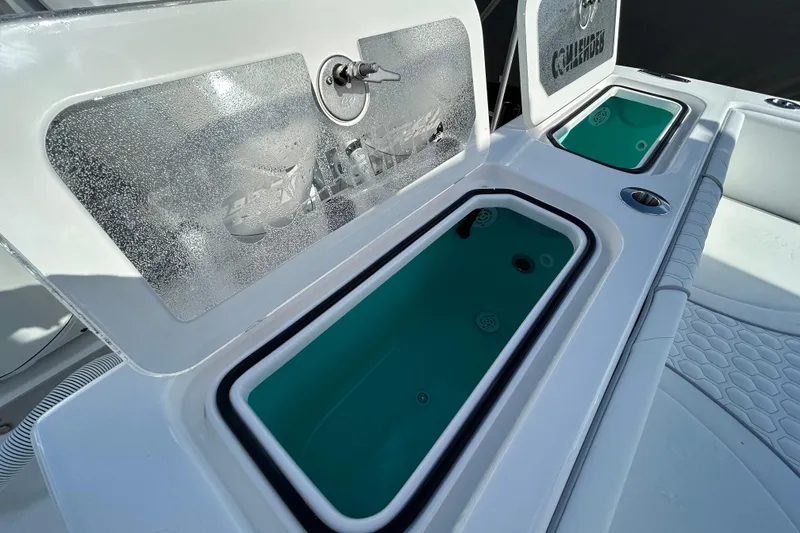 Slide: The Image of 2026 Contender 35 ST boat with open storage compartments and teal interior. - 25