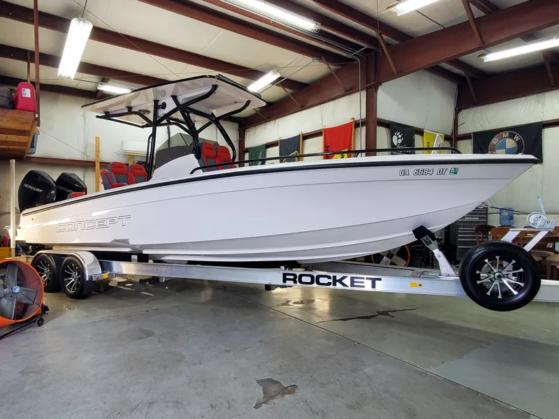 The Image of 2025 Concept Boats 27' CC on trailer in a garage setting. - 0