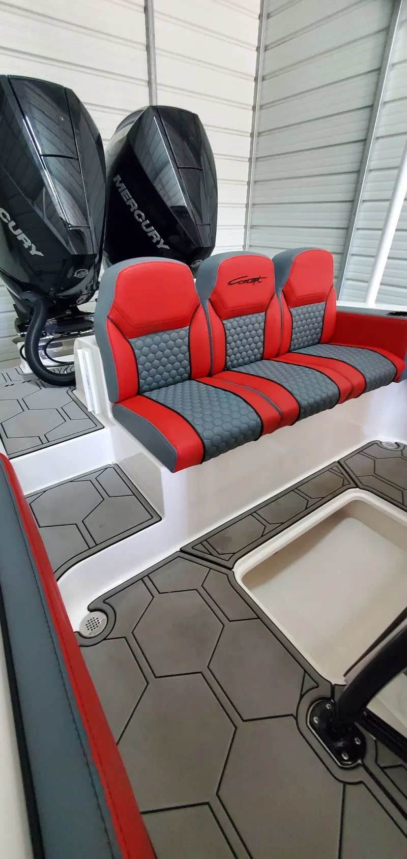 Slide: The Image of 2025 Concept Boats 27' CC with red and gray seating, dual Mercury engines, and hexagonal flooring. - 10