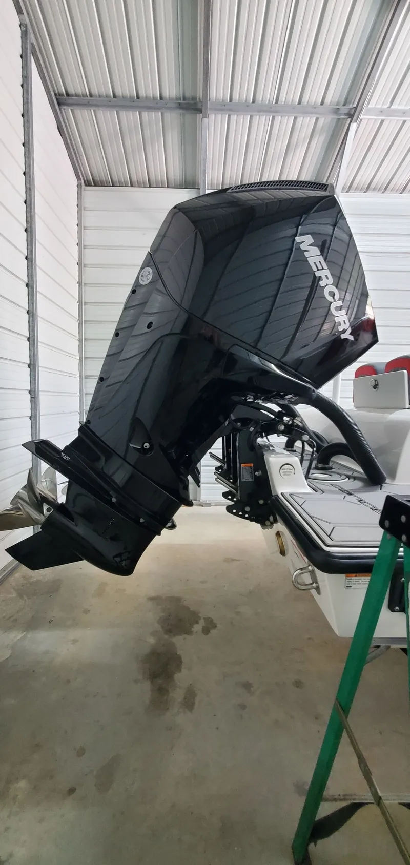 Slide: The Image of 2025 Concept Boats 27' CC with Mercury outboard engine in a covered storage. - 8