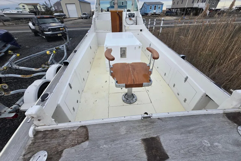 Slide: The Image of 1964 Whiticar 24 boat interior with wooden chair and storage compartments. - 11