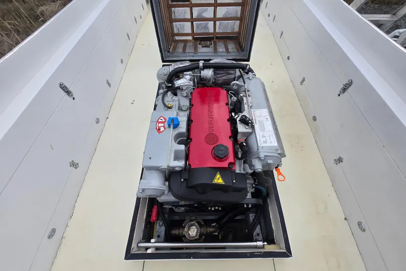 Slide: The Image of Engine compartment of a 1964 Whiticar 24 boat, featuring a prominently displayed engine. - 14