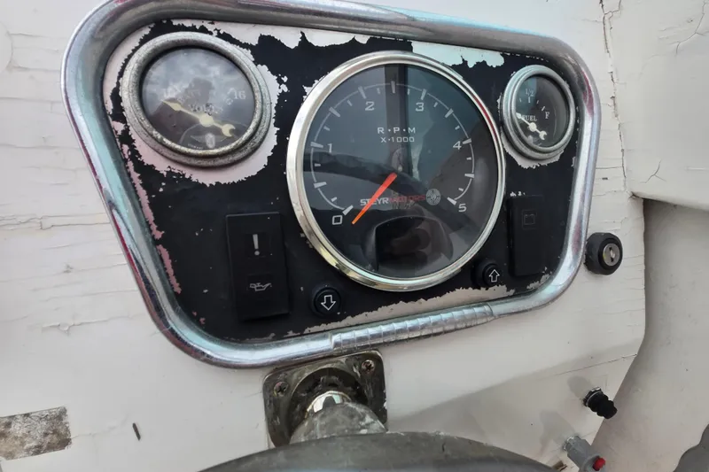 Slide: The Image of 1964 Whiticar 24 boat dashboard with RPM, fuel, and voltage gauges. - 17