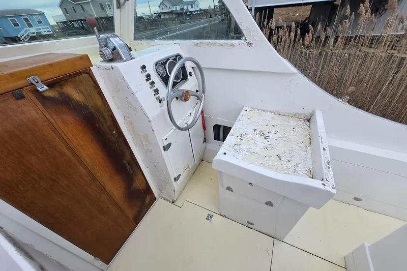 Slide: The Image of 1964 Whiticar 24 boat interior with vintage steering wheel and weathered wood paneling. - 20