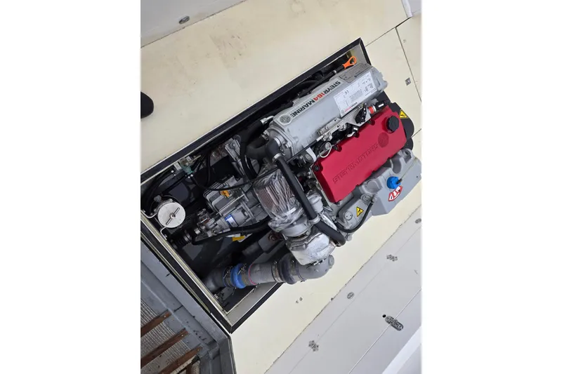 Slide: The Image of 1964 Whiticar 24 boat engine with red and silver components, detailed view. - 27