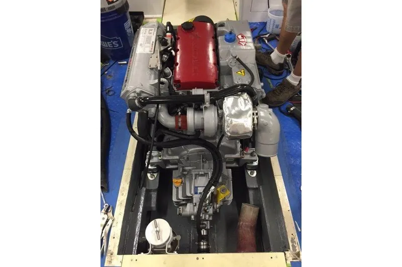 Slide: The Image of 1964 Whiticar 24 engine with red and silver components, installed in a boat. - 35