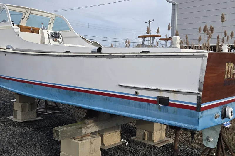 Slide: The Image of 1964 Whiticar 24 boat on blocks, showcasing classic design and vintage details. - 6