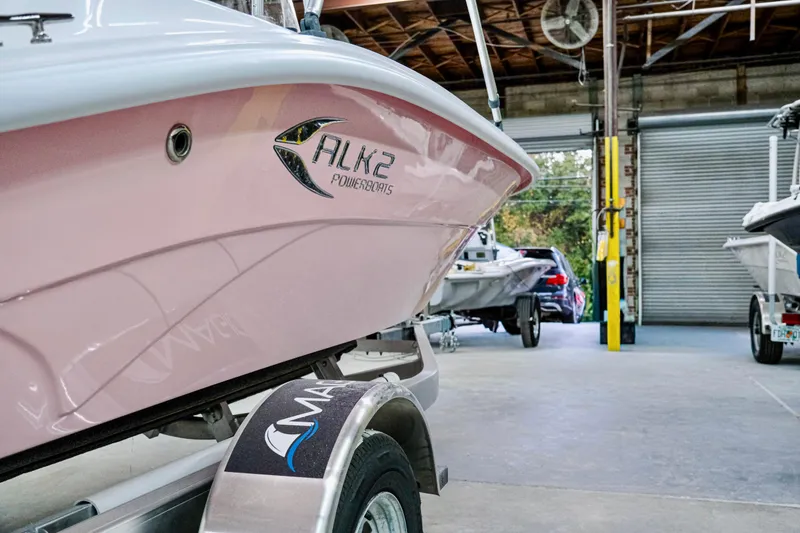 Slide: The Image of 2026 ALK2 Powerboats 18 CRS in a garage, showcasing sleek design and branding. - 12