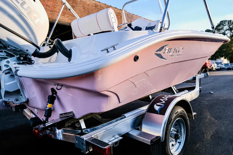 Slide: The Image of 2026 ALK2 Powerboats 18 CRS in pink on a trailer, featuring Suzuki engine. - 17