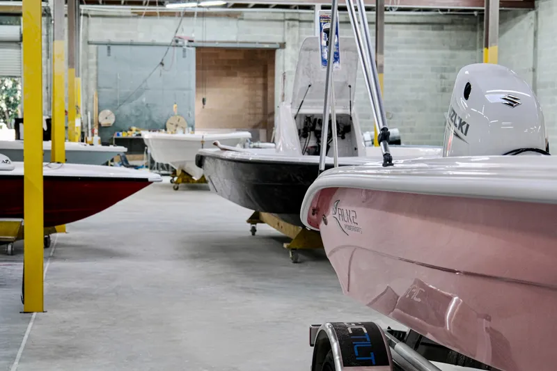 Slide: The Image of 2026 ALK2 Powerboats 18 CRS in a showroom with other boats. - 4