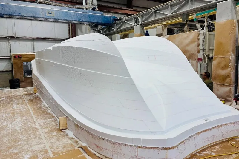 Slide: The Image of 2026 Front Runner 34 Catamaran hull in a manufacturing facility. - 9