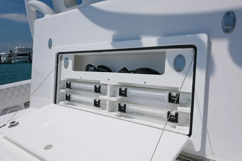 Slide: The Image of Storage compartment on 2026 Front Runner 35 Catamaran, featuring organized tackle boxes and equipment. - 16
