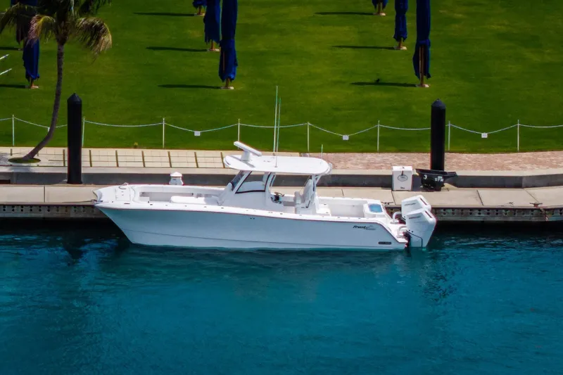 Slide: The Image of 2026 Front Runner 35 Catamaran docked by a lush green lawn. - 5