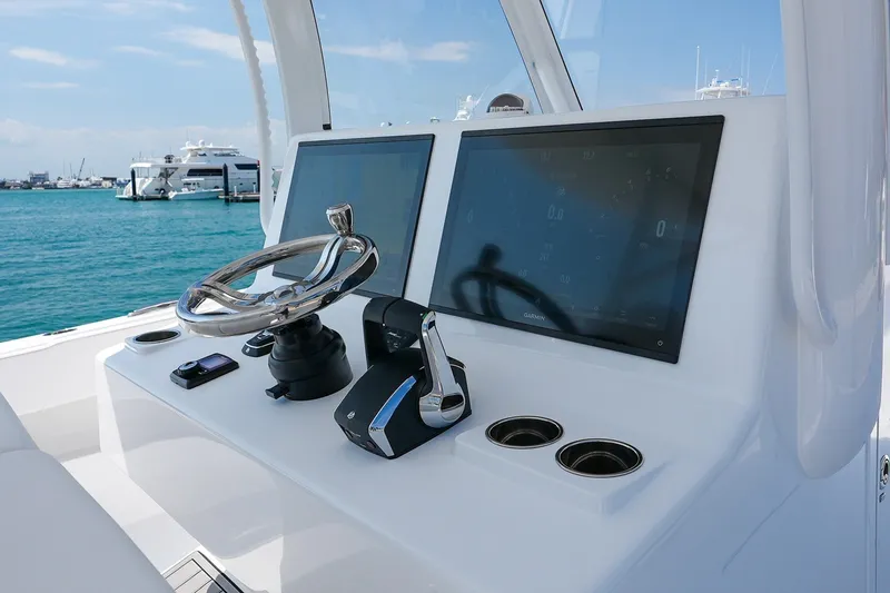 Slide: The Image of Helm of 2026 Front Runner 35 Catamaran with dual screens and steering wheel. - 9