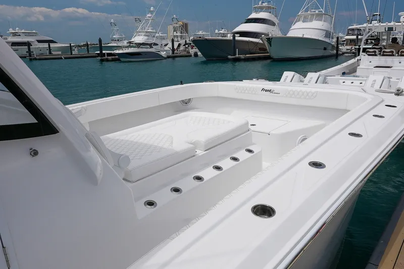 Slide: The Image of 2026 Front Runner 35 Catamaran docked, showcasing sleek design and spacious deck. - 13