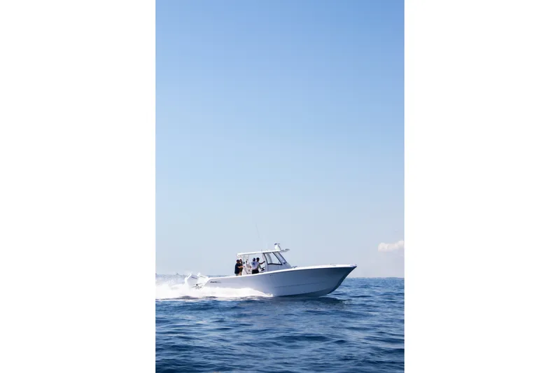 Slide: The Image of 2026 Front Runner 35 Catamaran cruising on open water under clear blue sky. - 19