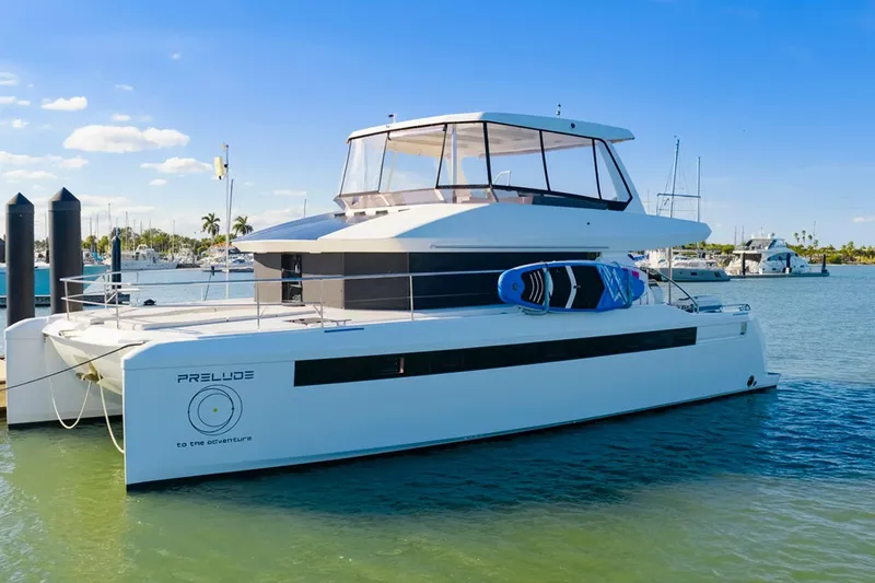 The Image of 2024 Leopard 46 Powercat yacht docked, featuring sleek design and paddleboards on deck. - 0