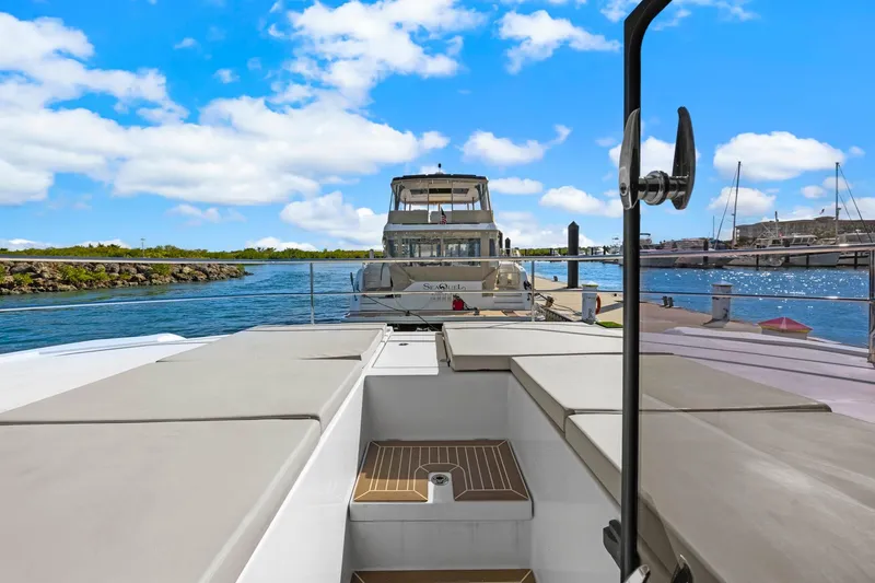 Slide: The Image of 2024 Leopard 46 Powercat yacht docked at marina under blue sky. - 15