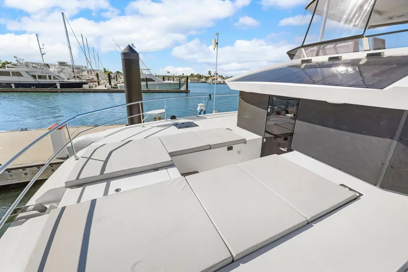 Slide: The Image of 2024 Leopard 46 Powercat yacht with spacious deck, docked at marina under blue sky. - 16