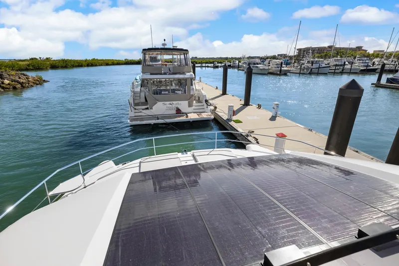 Slide: The Image of 2024 Leopard 46 Powercat docked at marina, sunny day, clear blue sky. - 17