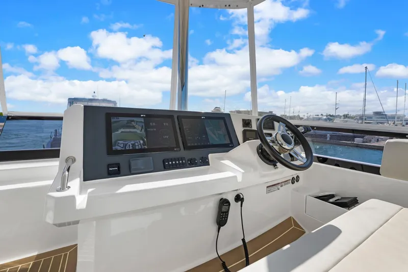 Slide: The Image of 2024 Leopard 46 Powercat helm with modern navigation displays and steering wheel. - 20