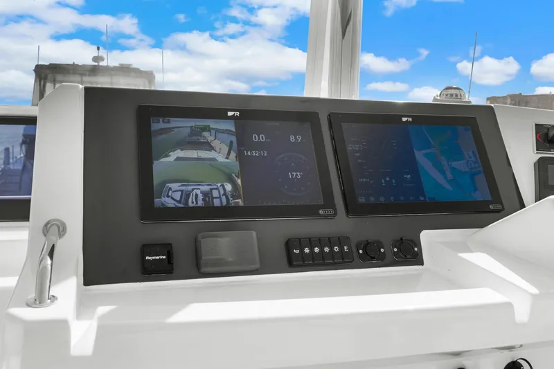 Slide: The Image of Helm of 2024 Leopard 46 Powercat with dual navigation screens and controls. - 21