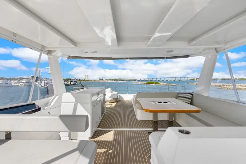 Slide: The Image of 2024 Leopard 46 Powercat yacht interior with seating area and ocean view. - 23