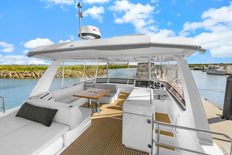 Slide: The Image of 2024 Leopard 46 Powercat yacht with spacious deck and modern design, docked in a scenic marina. - 25