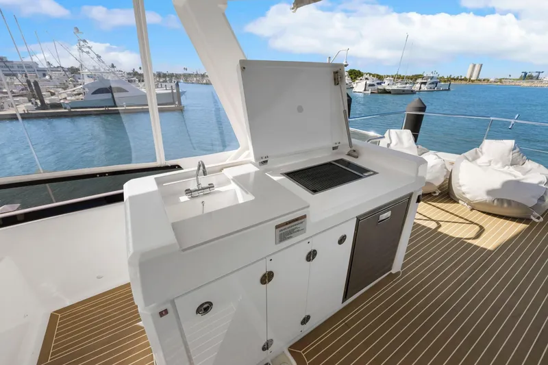 Slide: The Image of Outdoor kitchen on 2024 Leopard 46 Powercat yacht with sink and grill, docked at marina. - 29
