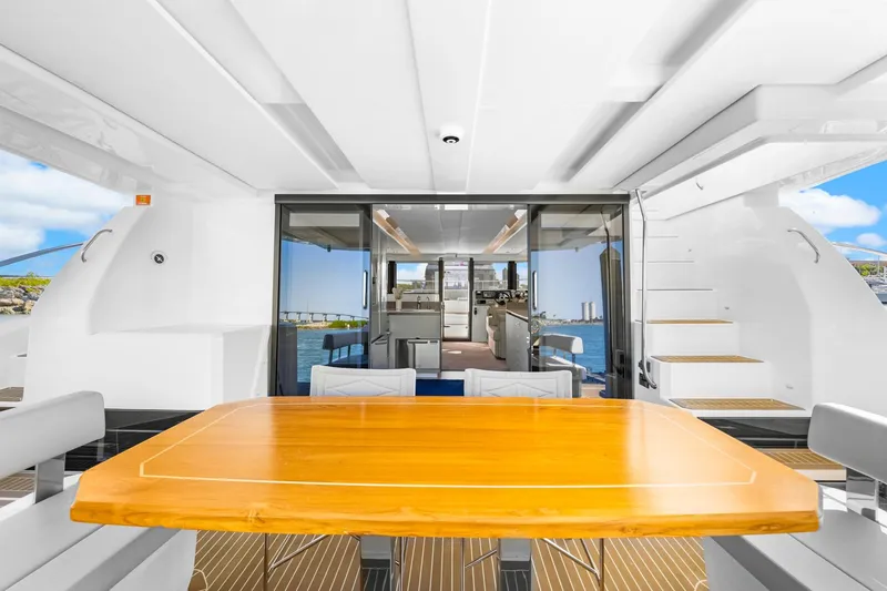 Slide: The Image of 2024 Leopard 46 Powercat yacht interior with dining area and ocean view. - 41