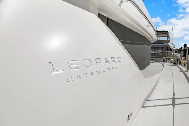 Slide: The Image of 2024 Leopard 46 Powercat catamaran with sleek design and branding. - 43