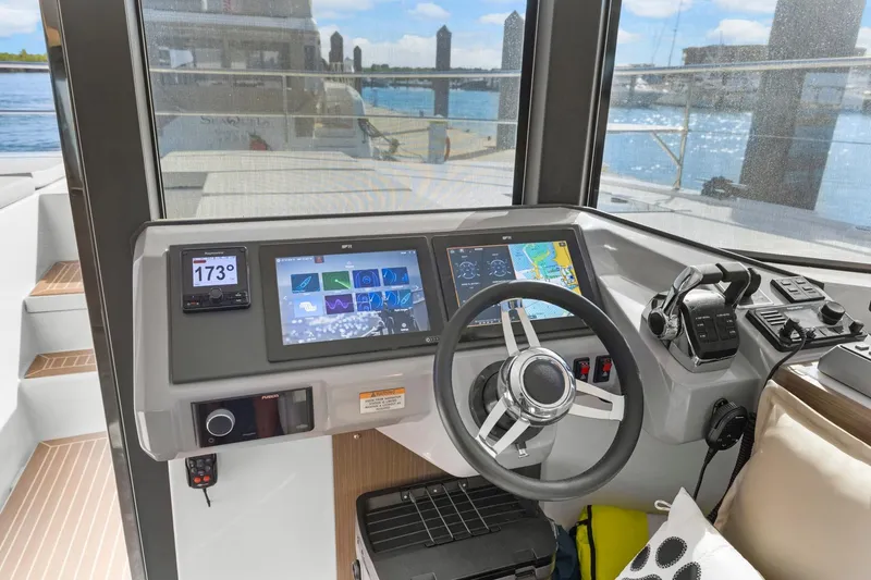 Slide: The Image of 2024 Leopard 46 Powercat helm with advanced navigation displays and controls. - 44