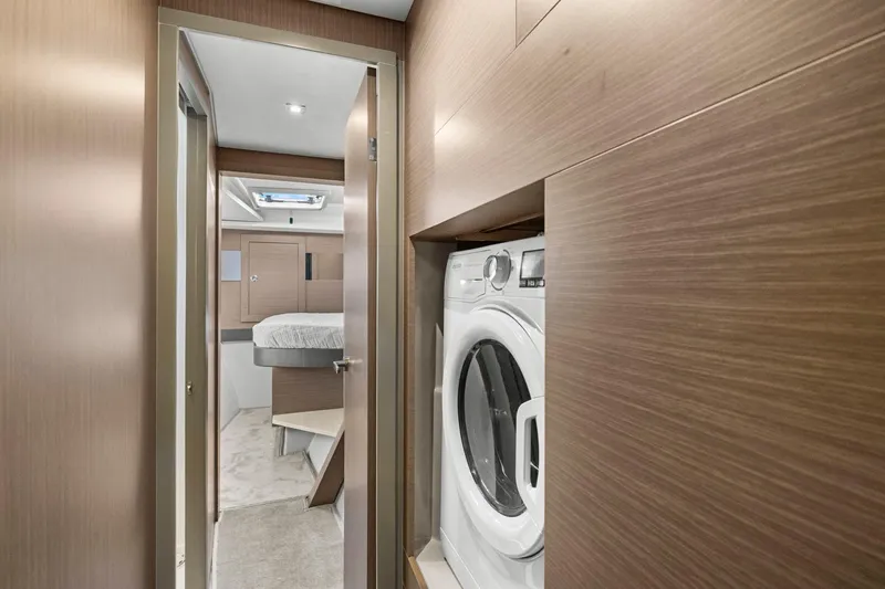 Slide: The Image of 2024 Leopard 46 Powercat interior with washer and bedroom view. - 61