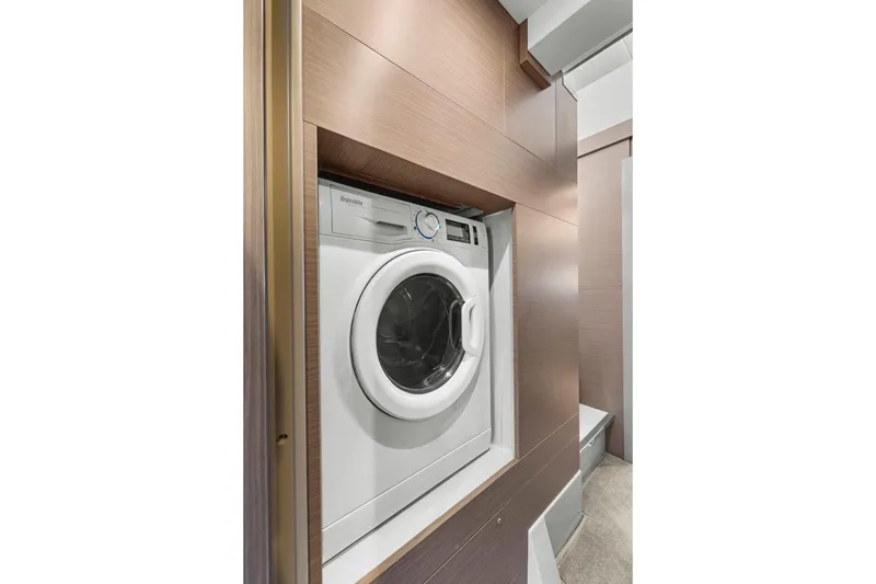 Slide: The Image of Washing machine in 2024 Leopard 46 Powercat yacht interior, sleek wood paneling. - 62