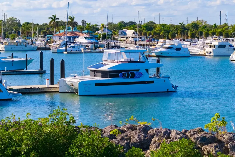 Slide: The Image of 2024 Leopard 46 Powercat yacht docked in a vibrant marina setting. - 7
