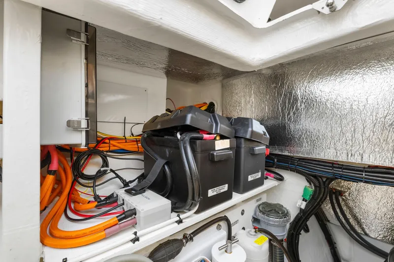 Slide: The Image of 2024 Leopard 46 Powercat engine room with batteries and wiring. - 78