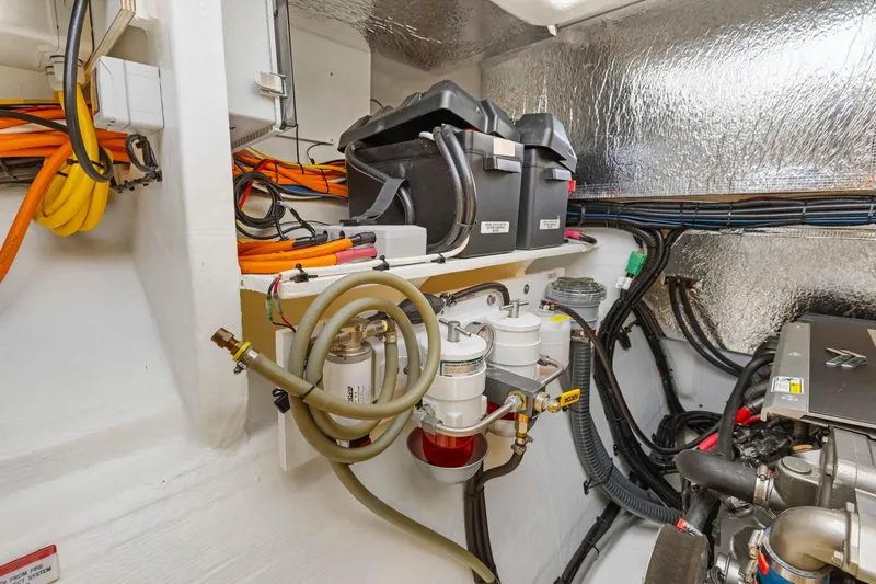 Slide: The Image of Engine room of 2024 Leopard 46 Powercat with wiring and fuel filters. - 79