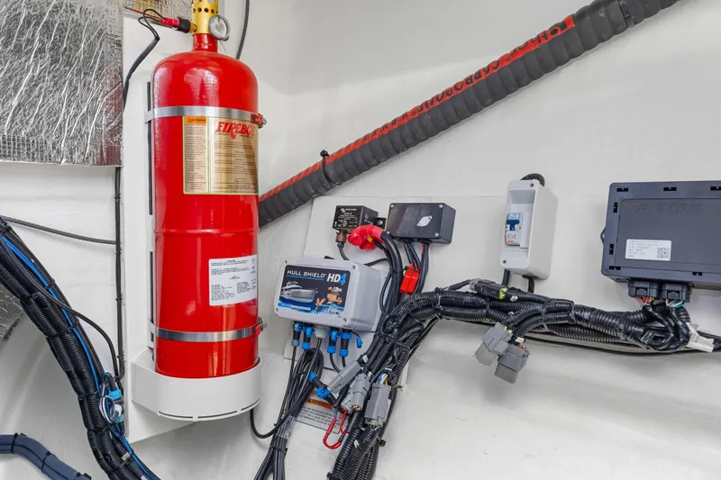 Slide: The Image of Engine room of 2024 Leopard 46 Powercat with fire extinguisher and electrical components. - 80