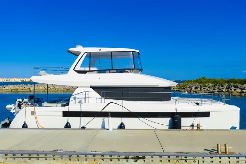 Slide: The Image of 2024 Leopard 46 Powercat yacht docked at a marina under clear blue skies. - 9
