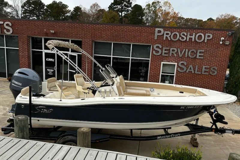 The Image of 2022 Scout 195 Sport Dorado boat on trailer outside service shop. - 1