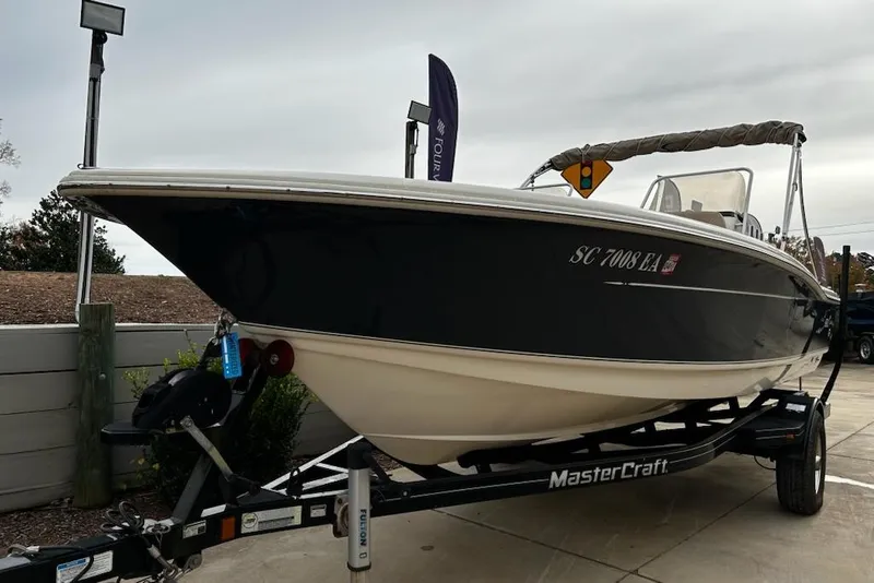 Slide: The Image of 2022 Scout 195 Sport Dorado boat on a MasterCraft trailer, parked outdoors. - 7